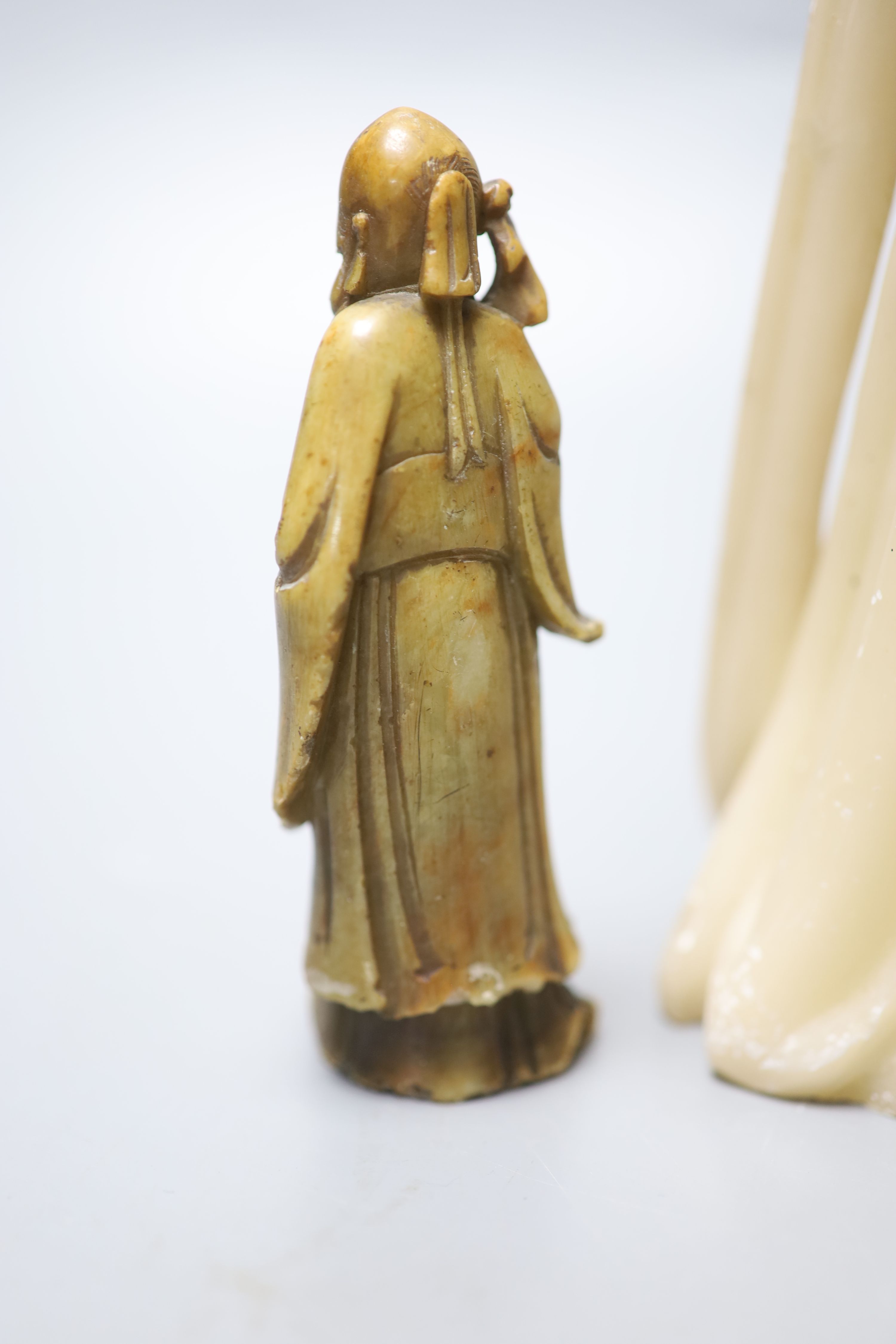 A large Chinese cream soapstone figure of an immortal, 41.5cm, (damaged) and a smaller 19th century Chinese russet soapstone figure of